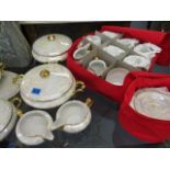 A Czechoslovakian lustre glazed, twelve setting dinner service, to include four tureens with lids