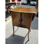 An Edwardian inlaid mahogany pot cupboard with twin fall flaps, a pair of doors raised on square