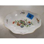 A 20th century Meissen porcelain dish of shaped oval form, decorated with a butterfly on a floral