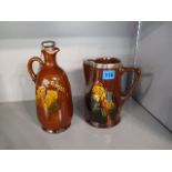 A Royal Doulton decanter with silver top, along with a matching water jug with silver top