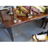 An Edwardian mahogany extending dining table, 29 h, 60 w