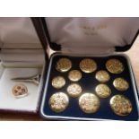 A boxed set of twelve Firmin & Sons buttons, together with a silver golf tee and lapel badge