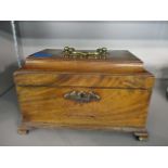 A George III mahogany tea casket with a rising moulded lid and closing twin lidded compartments,