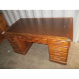 An early 20th century mahogany nine-drawer twin pedestal desk on castors, 30 h x 60 w