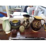 A selection of water jugs and other ceramics to include a Buckfast Abbey water jug, 10 h