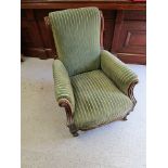 A Victorian mahogany, green upholstered arm chair with scrolled end back, on turned, fluted and