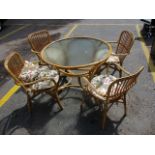 A mid 20th century bamboo conservatory suite, comprising a glass topped table, 28 h x 38 diameter,