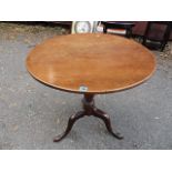 A George III mahogany, circular tripod table, vase shaped turned columns standing on cabriole