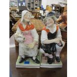 A pair of late Victorian pottery figures of a lady and a gentleman on a plinth, 13 h, A/F