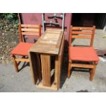 A modern teak drop leaf garden table and a matching pair of chairs