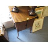 An Edwardian inlaid mahogany pot cupboard with twin fall flaps, a pair of doors raised on square