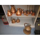 20th Century copperware to include a graduated set of eight measuring jugs