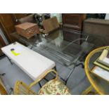 A large modern, wrought iron and glass topped dining table with door beneath the glass, 31 1/2h,