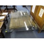 A wrought iron framed, glass topped coffee table with ornate carved door, 18 h, 46 w, 69 l