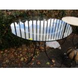 A modern wrought steel and circular glass topped table, 30 h x 35 1/2 w