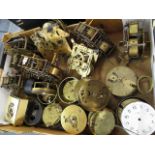 A large collection of Victorian and later clock bezels and dials, together with clock movements to