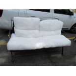 A wrought steel two seater sofa