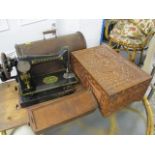 A Singer sewing machine and a treen carved box, 9 h x 18 w