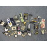 Zippo and vintage lighters, mixed bottle openers and corkscrews, coins and an ISAF medal, two clay