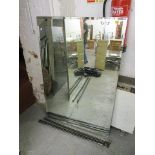 A large modern wall mirror with wrought iron supports, 51 1/2 x 34