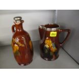 A Royal Doulton decanter with silver top, along with a matching water jug with silver top