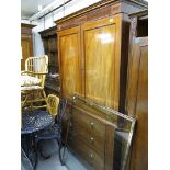 A late Victorian inlaid mahogany linen press with a pair of panelled doors, over three graduated