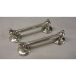 A pair of silver bell-shaped cutlery rests