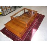 A modern cherry wood two tier glass topped table with a drawer, 16 h x 51 w x 27 1/2 d