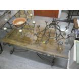 A large contemporary, glass topped coffee table on wrought iron supports, with treen door, 16 3/