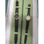 A Gucci gents quartz wrist watch on a leather strap, together with a matching ladies watch, both