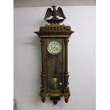 A late 19th century German walnut cased Vienna style regulator, with an eagle crest, glazed door and