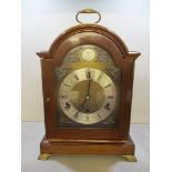 A late 20th century mahogany, chiming bracket clock by Elliott of London, the arched topped, stepped