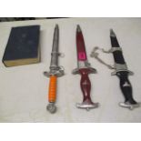 Three reproduction German daggers with sheaths, together with a Navy Officers dagger and a Mein