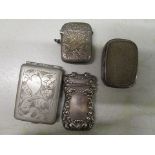 A group of three silver vesta cases and one silver plated card case,