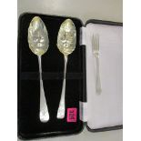 A pair of George III silver Old English pattern table spoons with berry embossed bowls and a