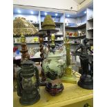 A selection of table lamps, spelter figurines and oak barley twist stands