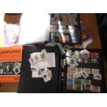 Mixed stamps in albums and loose from around the world and books on collecting stamps