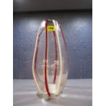 A clear glass vase with red and white streaked decoration, 12 1/4h