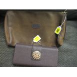 A Laura Mercier hard case clutch in dark brown with animal print effect clasp, 4 1/2h x 9w and a