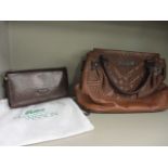 A Burberry leather handbag in brown, with iconic Burberry fabric interior, 10 h x 12 w and a Hansson
