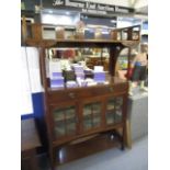 An Arts & Crafts Glasgow School mahogany, mirrored back sideboard, the shelf having a gallery over