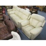 An electrically and manually operated reclining three piece suite upholstered in cream leather