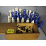 Two complete chess sets, one wooden, the other ceramic