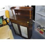 An early 19th century rosewood chiffonier having a shelf over turned pillars, above a frieze