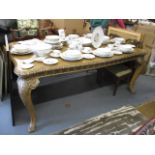 A mid 20th century silver painted and satin walnut extending dining table, raised on cabriole