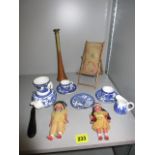 An 1895 needlepoint toy deck chair, a blue, white child's matched teaset, two china Red Indian