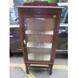 A 1920s oak display cabinet