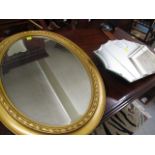 A modern gilt oval mirror, together with another mirror