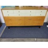 A retro G-Plan chest of four long drawers and two central cutlery drawers, flanked by four smaller