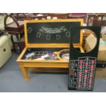 A modern pale oak gaming table having a removable top enclosing a roulette wheel, Blackjack board